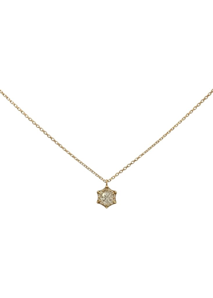 Necklace with a small rounded pendant in yellow and white gold featuring pavé diamonds, displayed on a white background.
