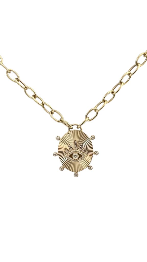 Elegant evil eye pendant necklace with sparkling diamonds and diamond bezels, set in luxurious 14K yellow gold on an 18-inch chain — meaningful symbolism and modern sophistication by LA brand Neshi.