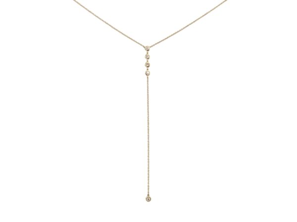 Lariat necklace featuring diamond bezels cascading down to a single diamond bezel drop, crafted in yellow gold — a refined and versatile piece for any occasion.