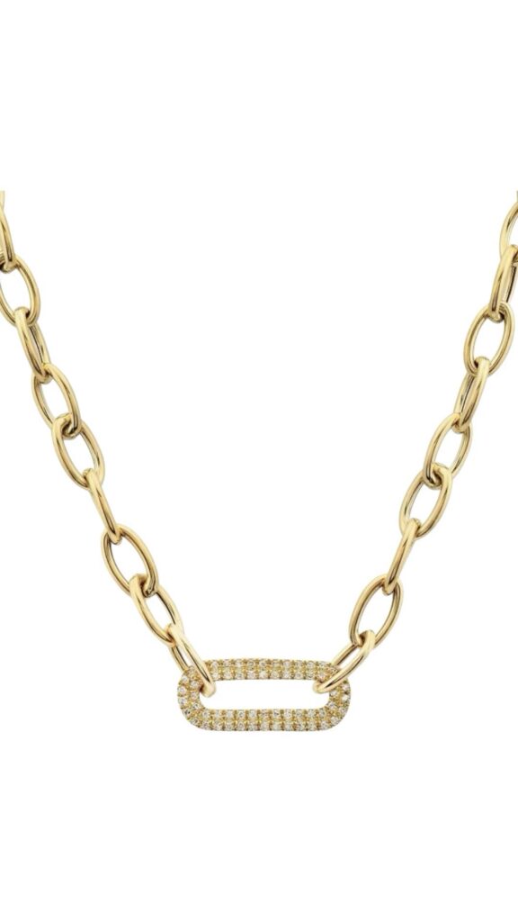 Gold necklace featuring an open paperclip-style pendant and small bezel-set stones along the chain, photographed on a white background.
