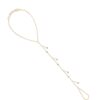 Gold hand chain with seven bezel-set diamond charms cascading along a delicate chain, connecting the wrist to a finger loop.