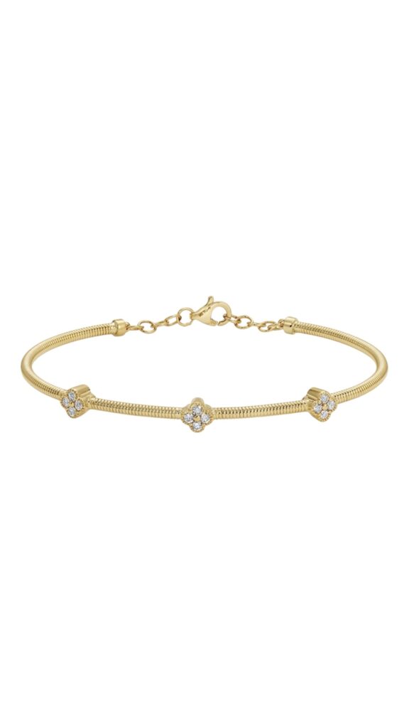 Gold omega chain bracelet with three small flower-shaped stone clusters evenly spaced along the band, shown against a white background.