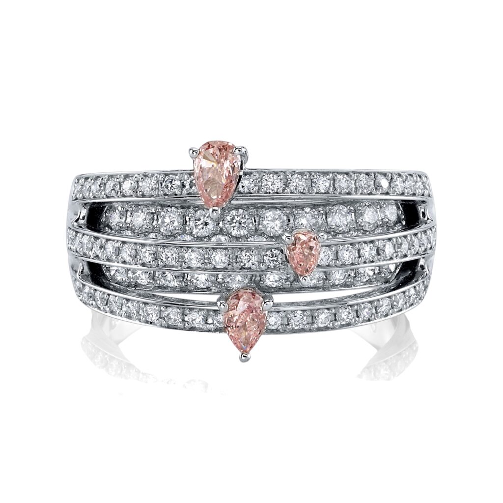 Platinum ring with five rows of white round diamonds and three pear-shaped pink diamonds set in a diagonal pattern.