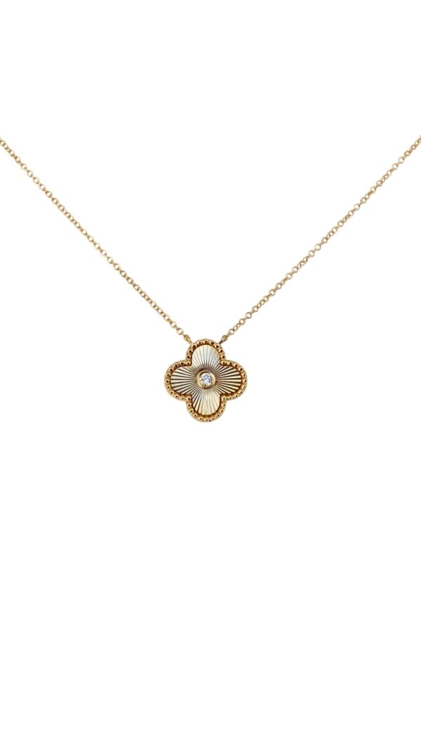 Gold necklace with a four-leaf clover-shaped pendant featuring a sunburst texture and center stone, photographed on a white background.
