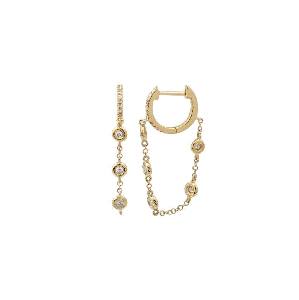 Yellow gold chain earrings with bezel-set round stones and dainty drop chains connecting pavé huggie hoops.